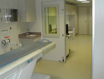 the inside of a mobile medical scanner room, with a sink and an MRI scanner