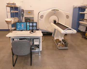 Diagnostic imaging scanner being tested with results show on computer monitor.