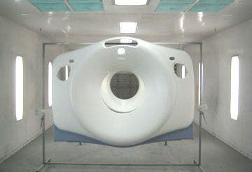 Front view of a CT scanner in a brightly lit room